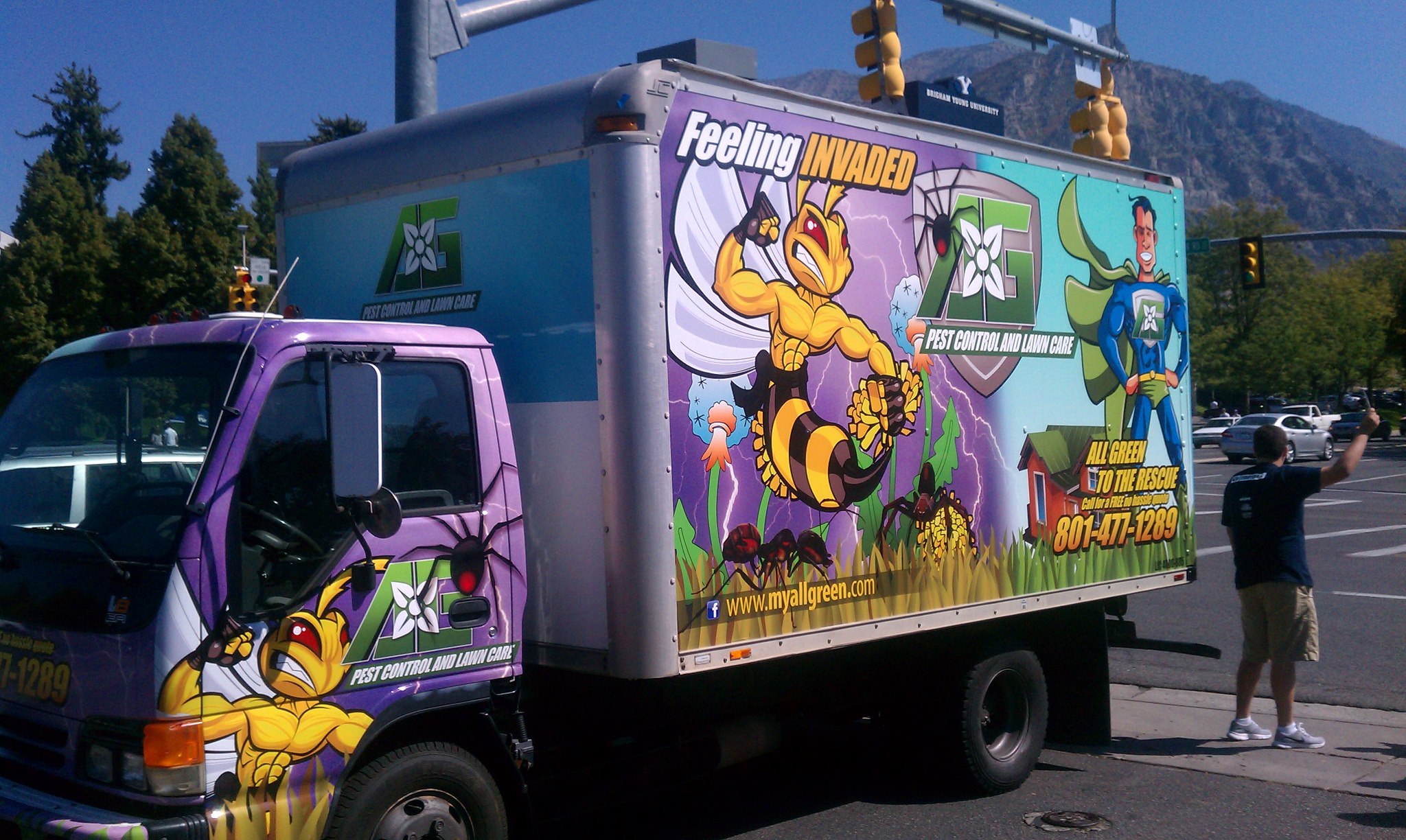 pest control truck advertising on a street corner